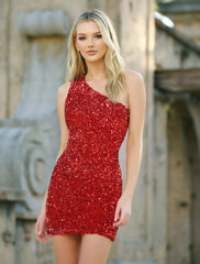 A young woman stands wearing a sparkling red dress with sequins, posing elegantly in front of a textured stone background that suggests an outdoor or architectural setting.