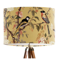 Pink and peach flowers and country garden birds on branches on a soft warm yellow background on a classic sized 30x21cm handcrafted fabric lampshade by artist Kelly Stevens-McLaughlan