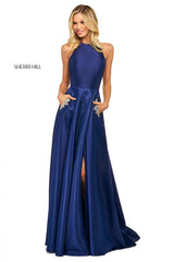 This Sherri Hill 53529 A-line satin gown in navy features a high cut halter style neckline and embellished skirt pockets.