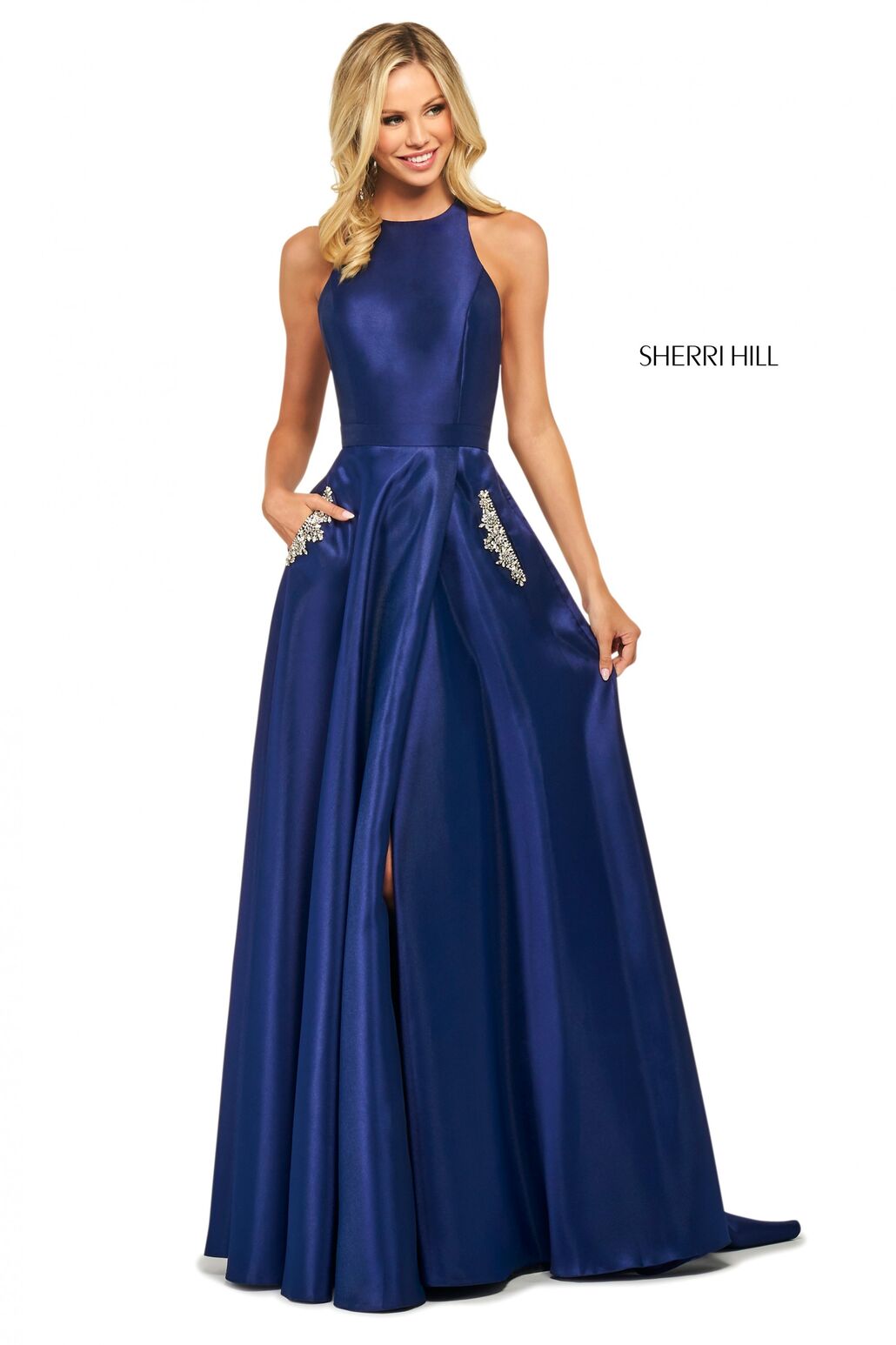 This Sherri Hill 53529 A-line satin gown in navy features a high cut halter style neckline and embellished skirt pockets.