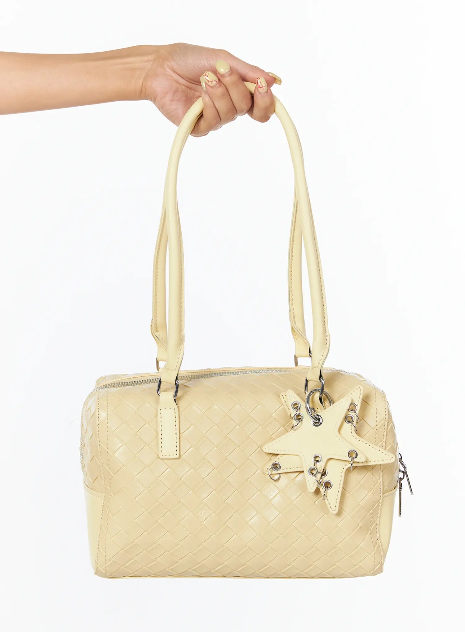 LEWKIN Vegan Leather Shoulder Bag With Keychain CU517 in yellow, hand-held product shot showing woven faux leather body, star-shaped keychain charm with silver eyelets, and dual top handles.