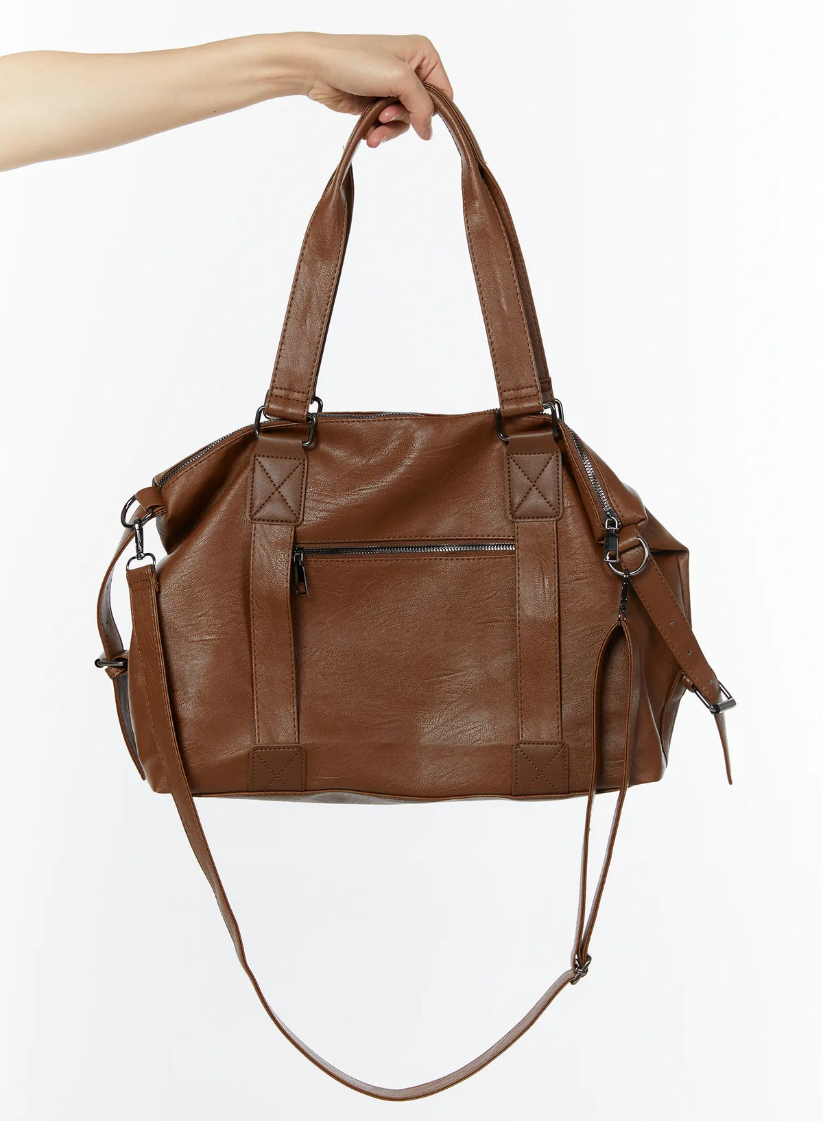 LEWKIN Unisex Leather Utility Bag IU515 in Brown, hand-held product shot showing front zip pocket, X-stitch hardware tabs, dual top handles, and removable crossbody strap.