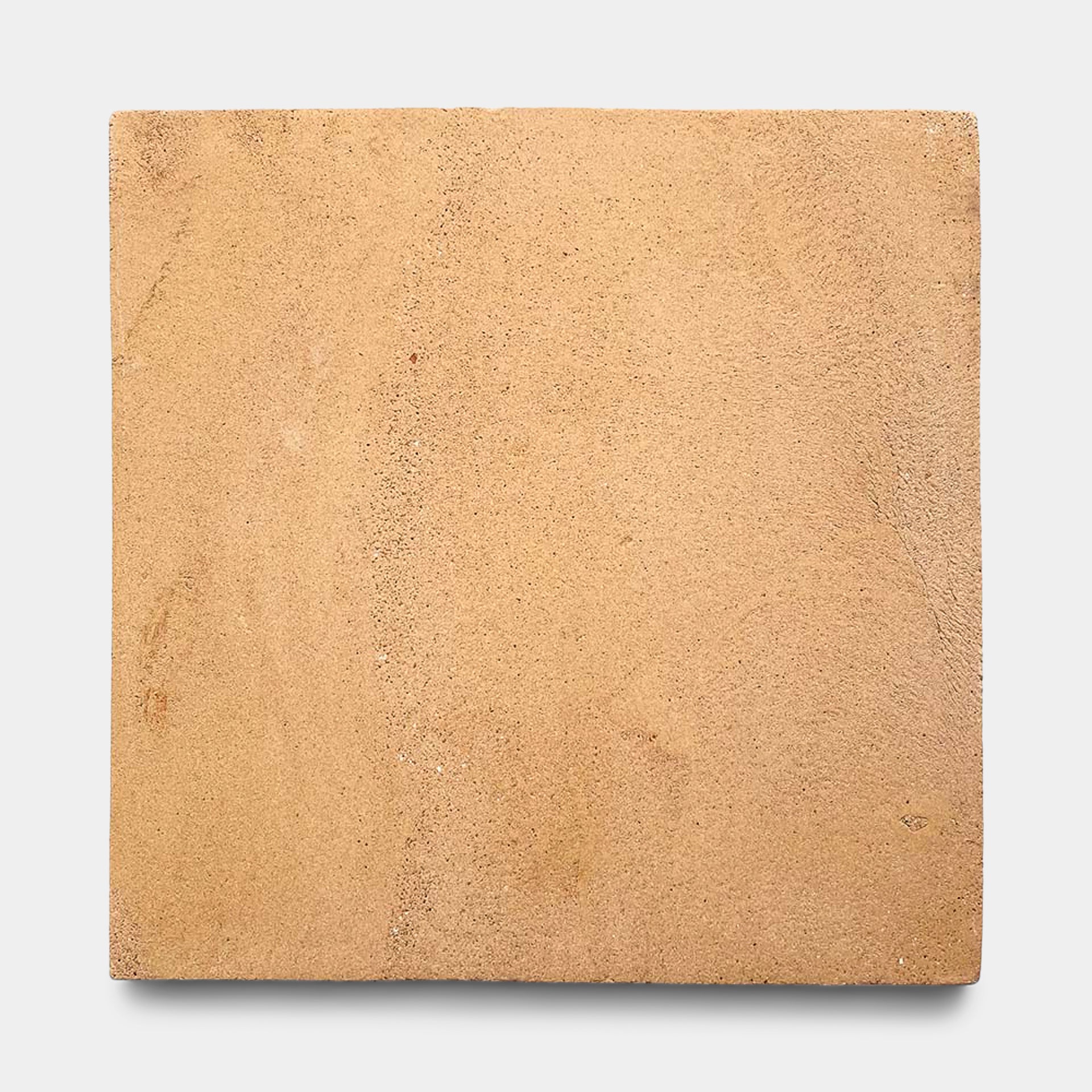 The Zia Tile 13x13 Square + Adobe is a flat, square, light brown sandstone tile with a subtly rough texture and natural variations, inspired by Mexican ceramic art, shown on a plain white background.