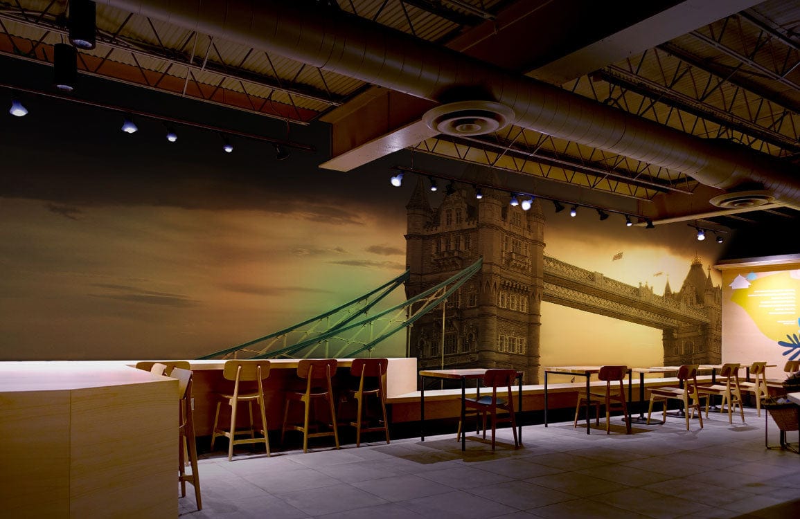 Vintage Sunset London Bridge mural wallpaper, warm tones, dining room, industrial ceiling, wooden chairs, tables.