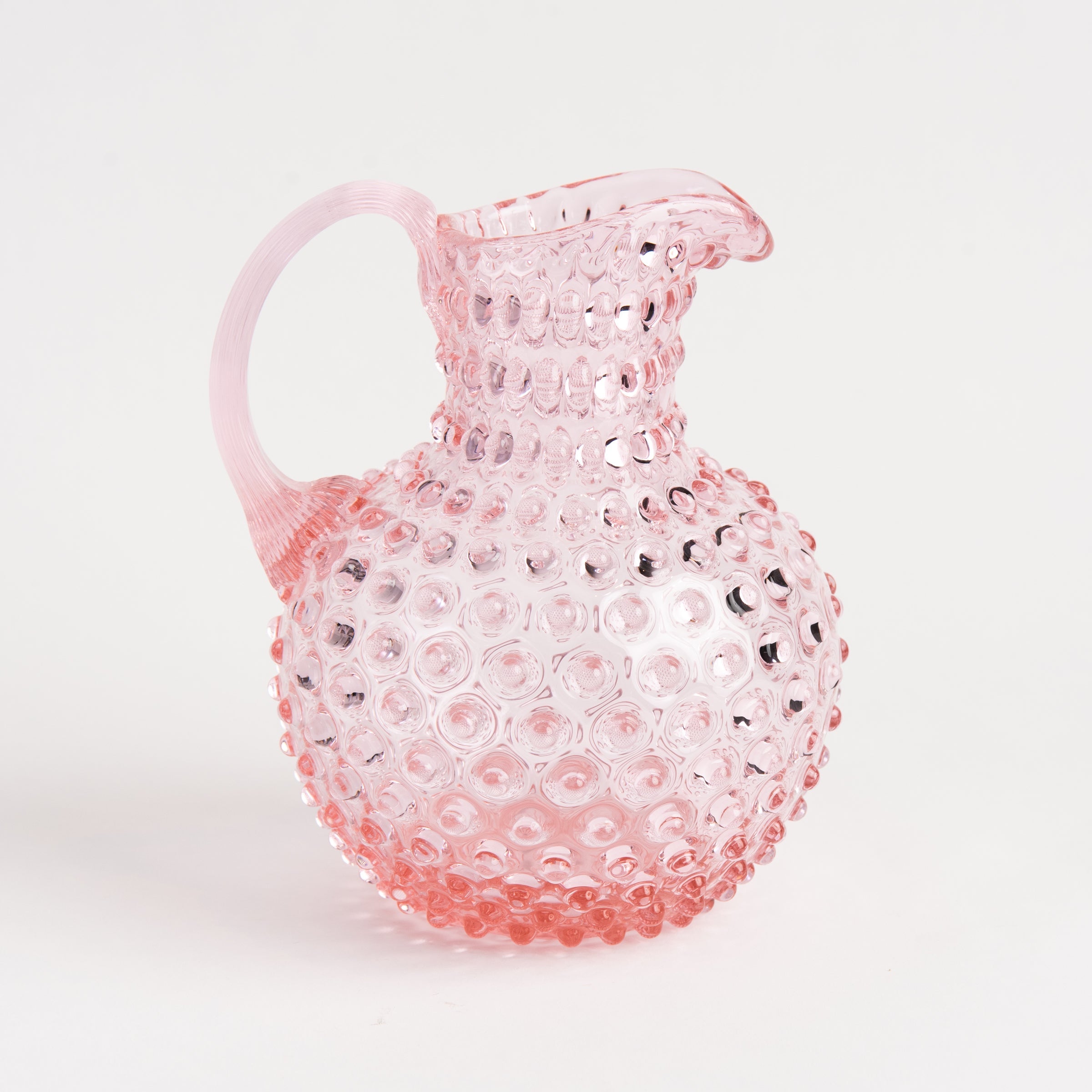 Hobnail Glass Pitcher in Petal Pink on a white background at Addison West