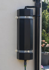 A black ButtBuddy rainwater management system mounted on a wall