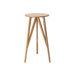 The JL7 Faber High Table by Loehr features a sleek, modern design with a round solid oak top and four angled outward-splaying legs. Its minimalist, northern European style highlights the natural wood grain for an elegant, contemporary look with both stability and style.