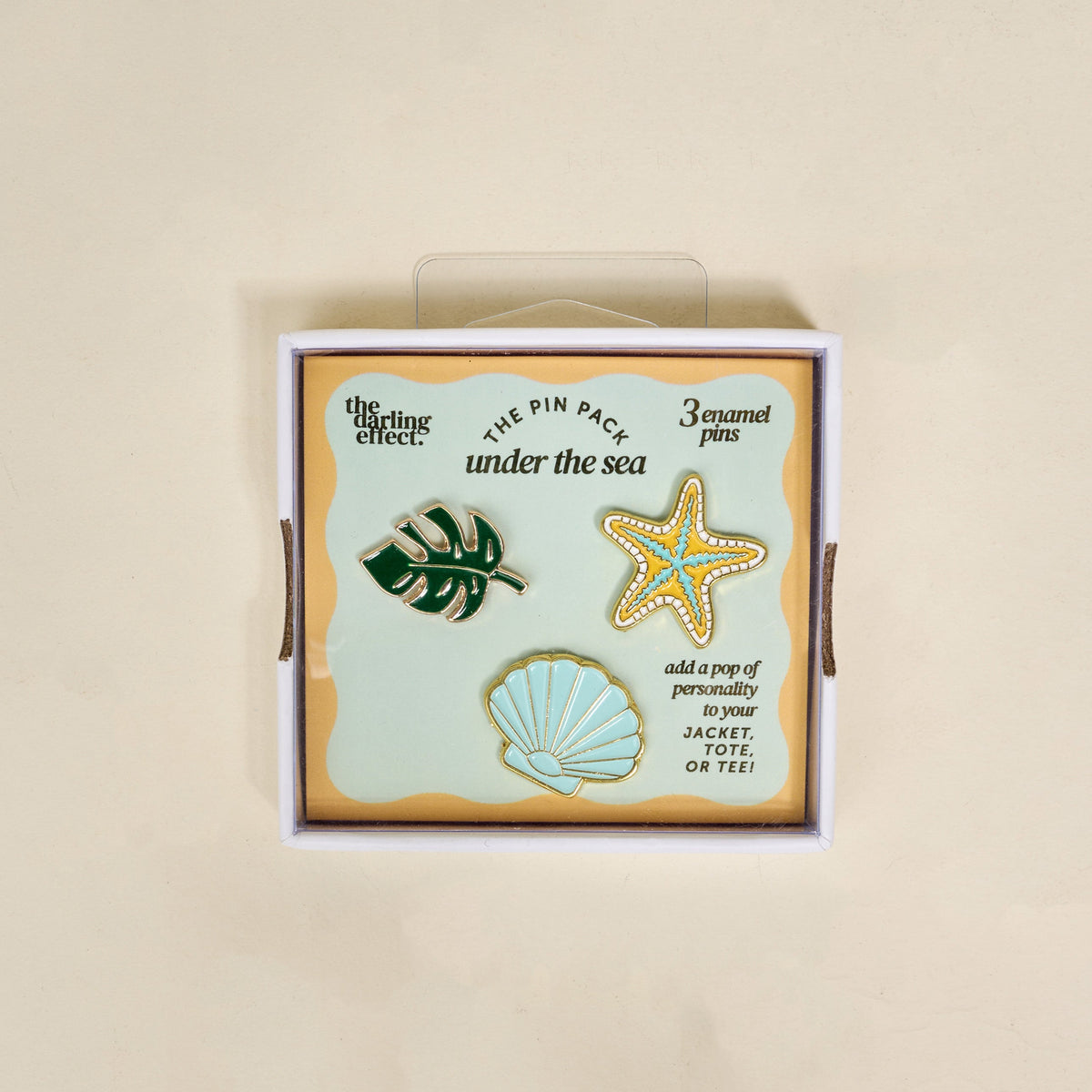 The Darling Effect’s Under the Sea The Pin Pack features three enamel pins—a monstera leaf, starfish, and scallop shell—ideal for collectors and accessory lovers.