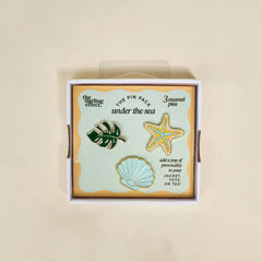 The Darling Effect’s Under the Sea The Pin Pack features three enamel pins—a monstera leaf, starfish, and scallop shell—ideal for collectors and accessory lovers.