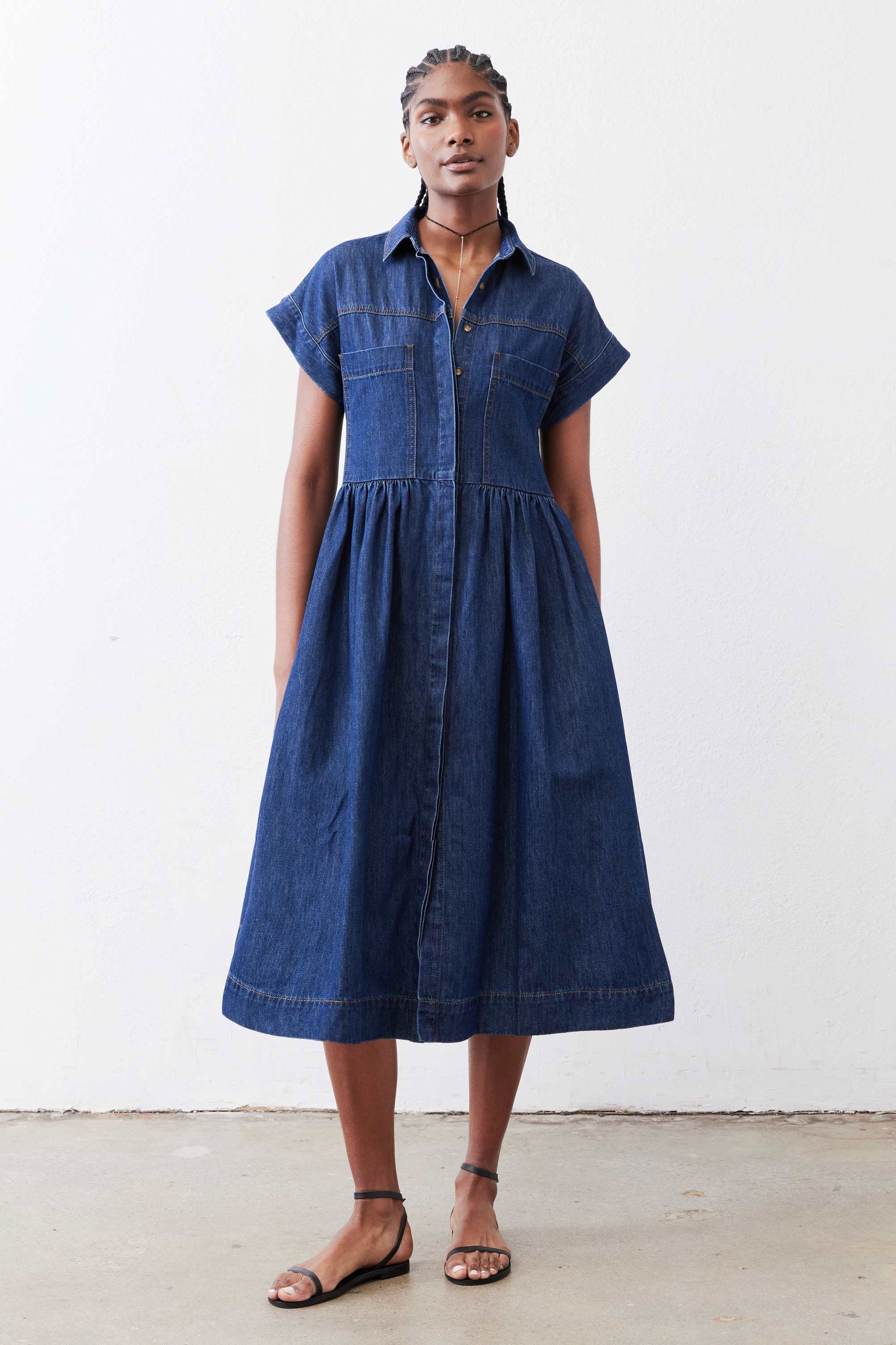 Medium-wash denim shirt dress with short sleeves, button placket, gathered skirt
