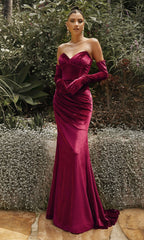 Surrounded by greenery, a woman stands outdoors wearing the Strapless Long Velvet Prom Dress with Gloves CH176—an elegant, floor-length, wine velvet gown paired with matching long gloves.