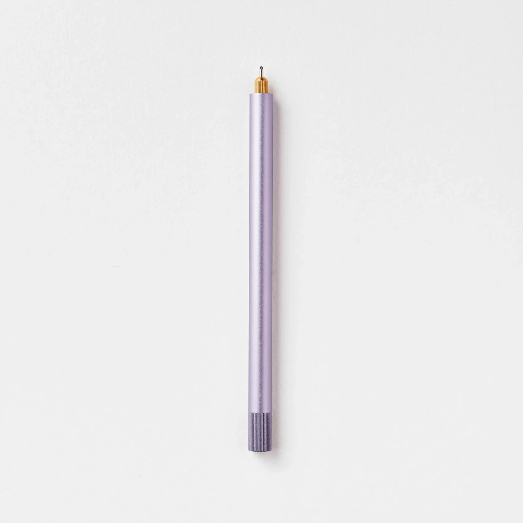 Tom's Studio Lumos Pro Single in Lilac (pale purple), fineline tip exposed, cap posted, on textured paper