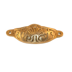 An image of a decorated brass knob against a neutral background. The knob features intricate patterns and designs, adding elegance and character to furniture or drawers.